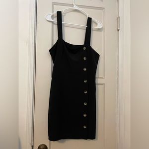 Black mini dress with button details.